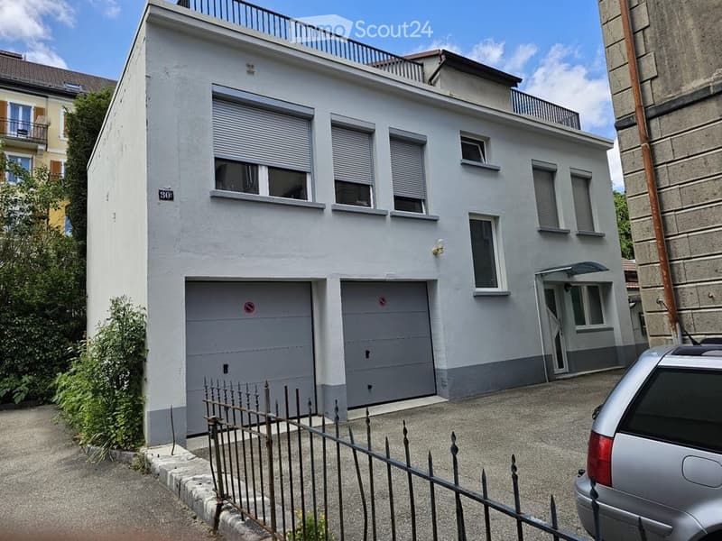 3-story house, white exterior, garage, fenced yard, balcony