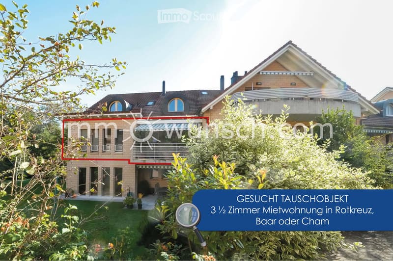 Two-story house with a tiled roof, multiple windows, and a balcony on the upper level. The house is surrounded by greenery and has a well-maintained garden.