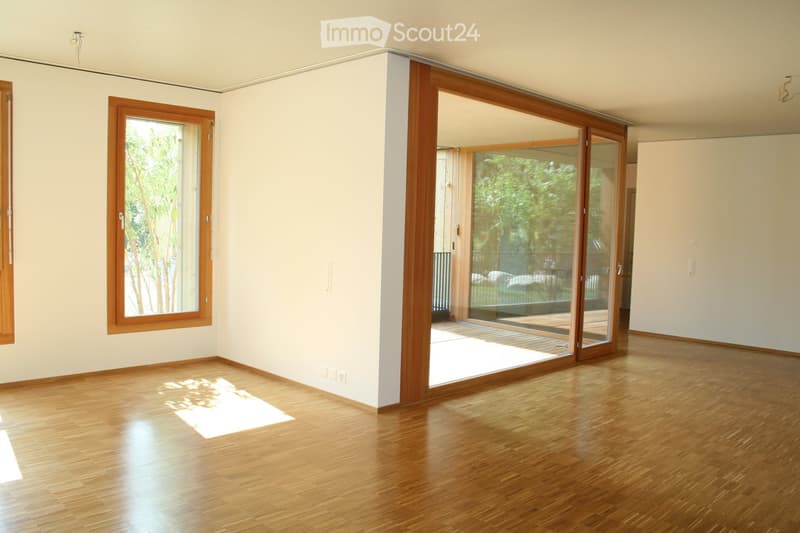 Open floor plan with wooden floor, large windows, balcony, bright, spacious, glass sliding doors