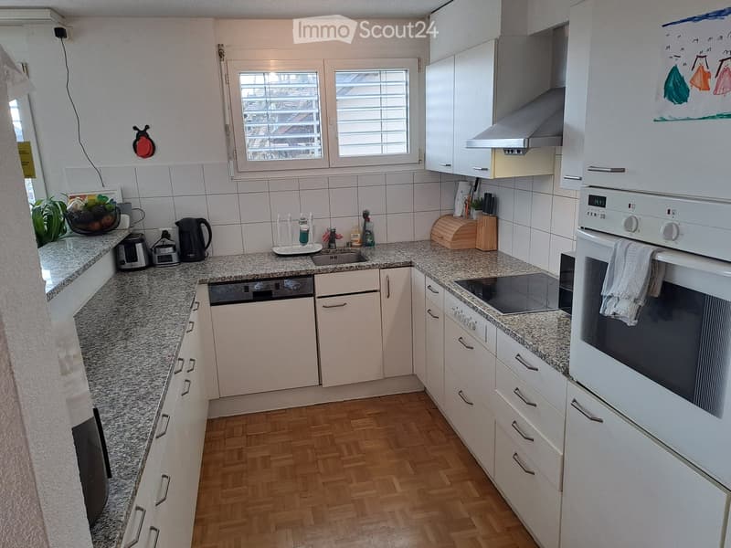modern kitchen with granite countertops, white cabinets, stainless steel appliances, window with blinds, wooden floor