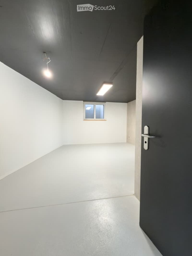 Completely empty room with white walls, white floor, and a single small window. No furniture or equipment.