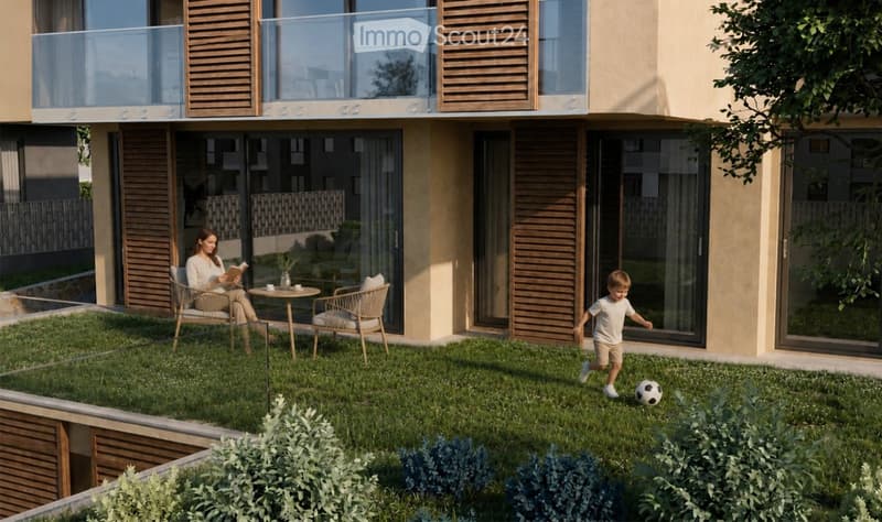 A modern apartment building with a small, well-maintained garden area. A woman is seated on a chair reading a book, and a child is playing with a soccer ball on the grass. The garden features a small table with a vase and two chairs, surrounded by neatly