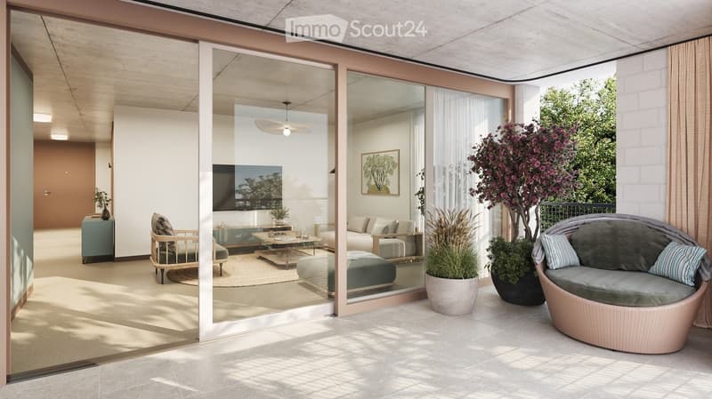 Modern living room with large glass sliding doors leading to a balcony, featuring a sofa, coffee table, ottoman, side table, and television. The balcony has a wicker chair, potted plants, and a view of greenery.