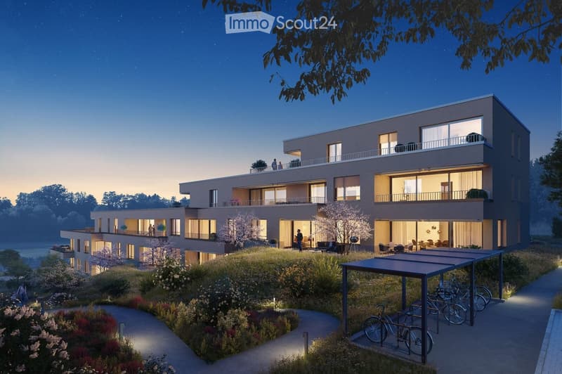 Modern two-story residential building with balconies, large windows, and a landscaped garden area with pathways and bicycles.