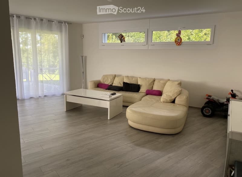 white couch, white coffee table, white curtains, balcony with metal railings, windows