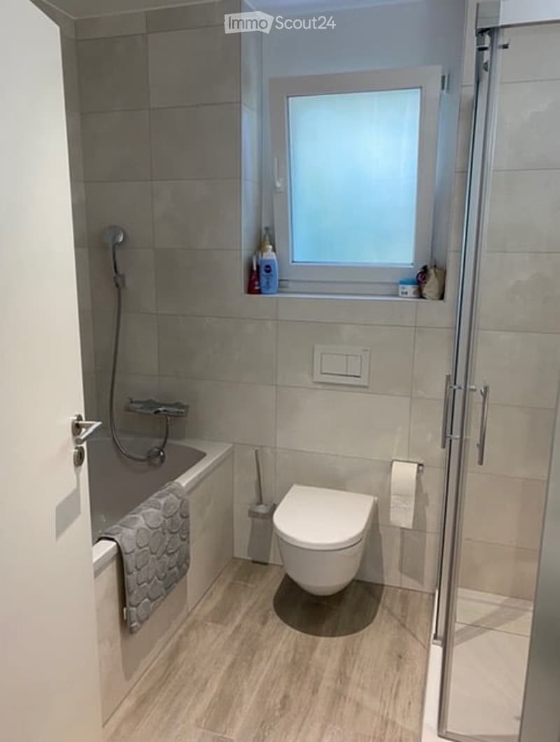 Bathroom with bathtub, toilet, shower, shelf, and window