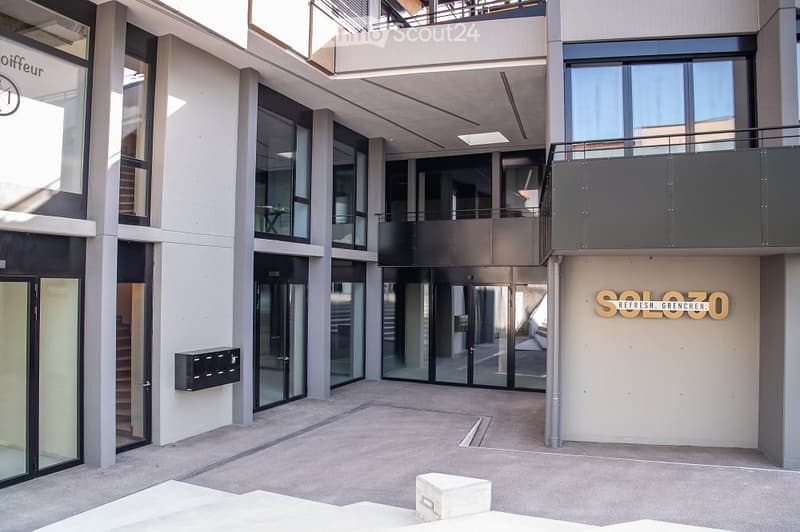Entrance of the building, modern architecture, balcony, glass doors, mail boxes, 'SOLOZO REFRESH GRENCHN' sign