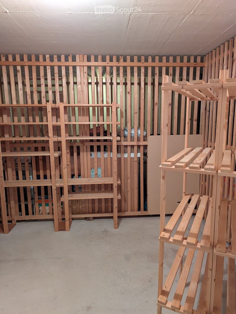 Empty room with unfinished wooden structures and a concrete floor, no furniture or equipment.
