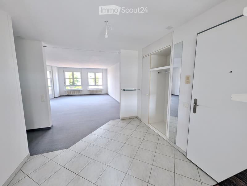 Empty room with white walls, tiled floor, and large windows. No furniture or equipment present.