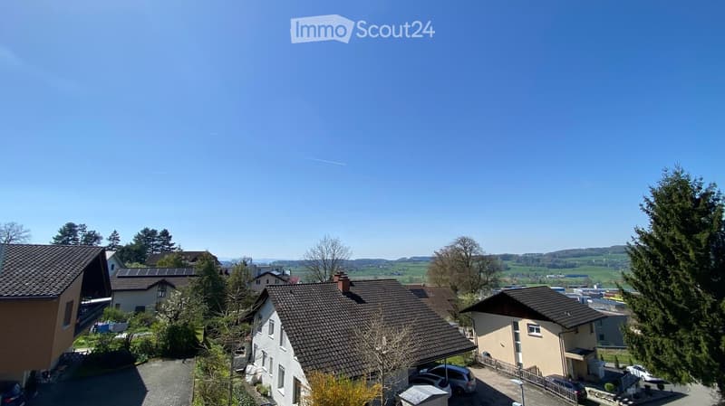 Residential neighborhood with multiple houses, solar panels, and a clear view of the countryside.
