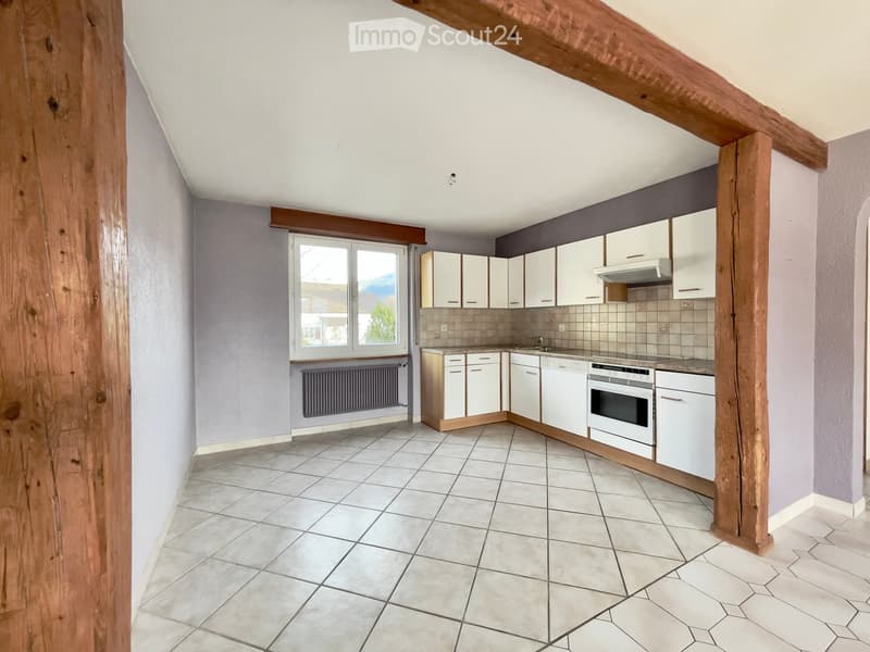 empty kitchen, tiled floor, white cabinets, window with view of mountains