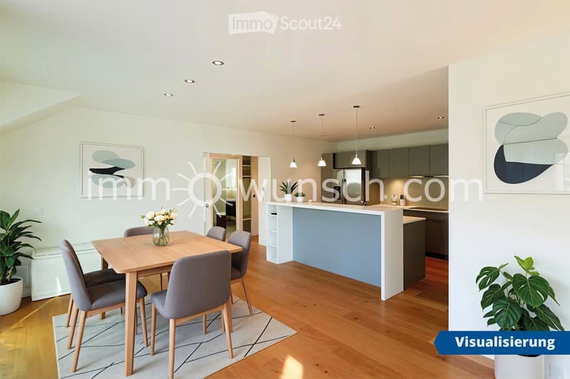 Open-plan living and dining area with a wooden dining table, grey chairs, a modern kitchen island, pendant lights, and decorative artwork on the walls.