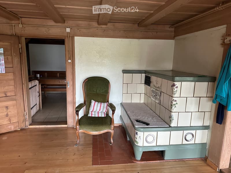 fireplace, wooden chair, remote, tiled flooring, wooden walls, wooden ceiling