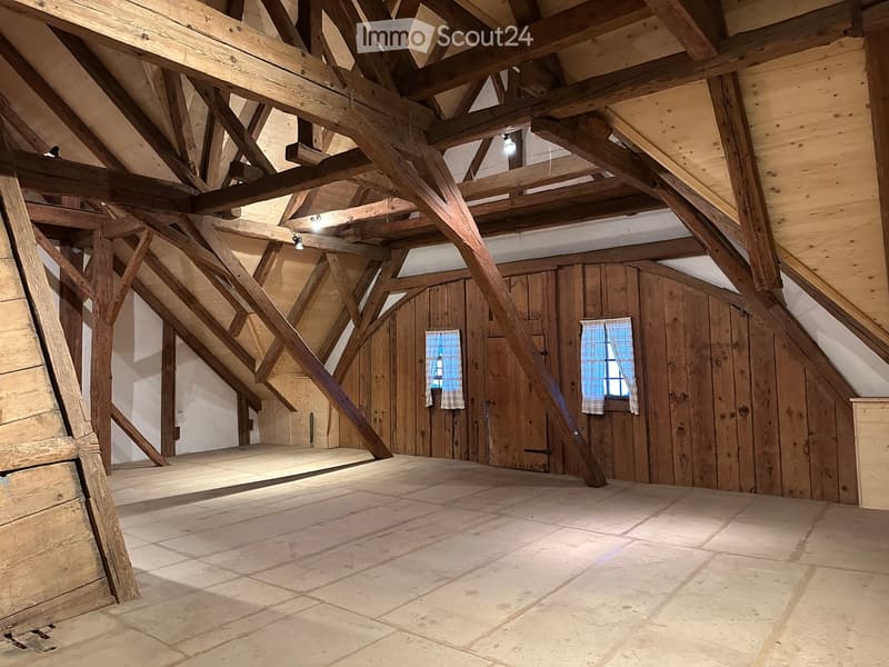 exposed wooden beams, wooden floor, 2 windows, two doors