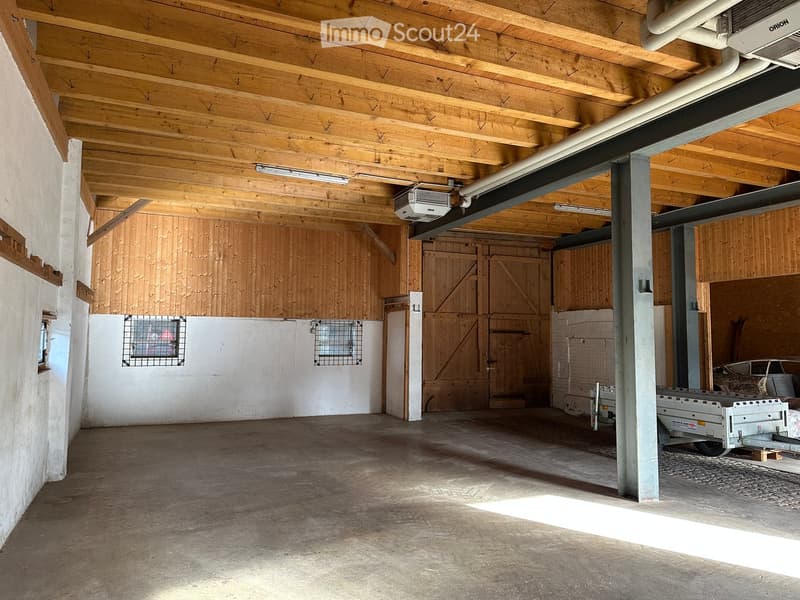 Empty room with wooden and white walls, wooden ceiling, a single trailer, a wall mounted air conditioner, and two windows.