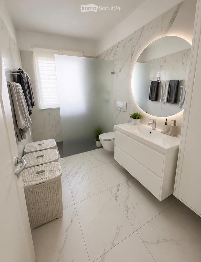 Modern bathroom with marble tiles, white sink, large round mirror, toilet, and wicker baskets.