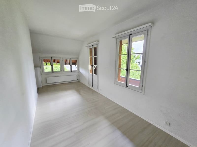 Empty room with white walls, wooden flooring, and multiple windows allowing natural light. No furniture or equipment present.