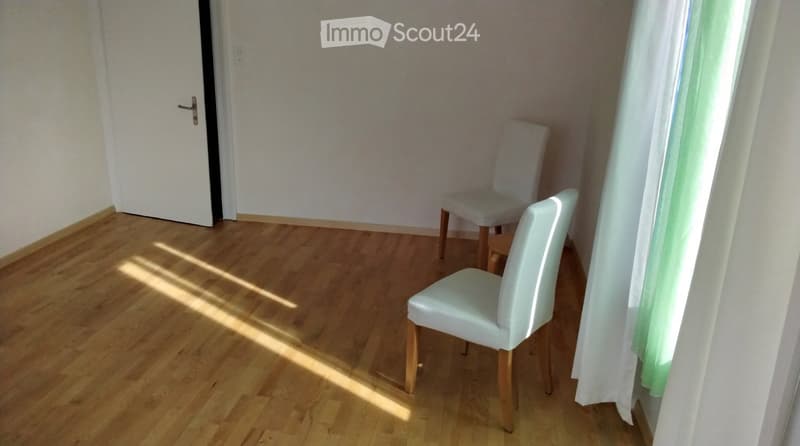 empty room, wooden floor, white walls, white door, two white chairs, white curtains