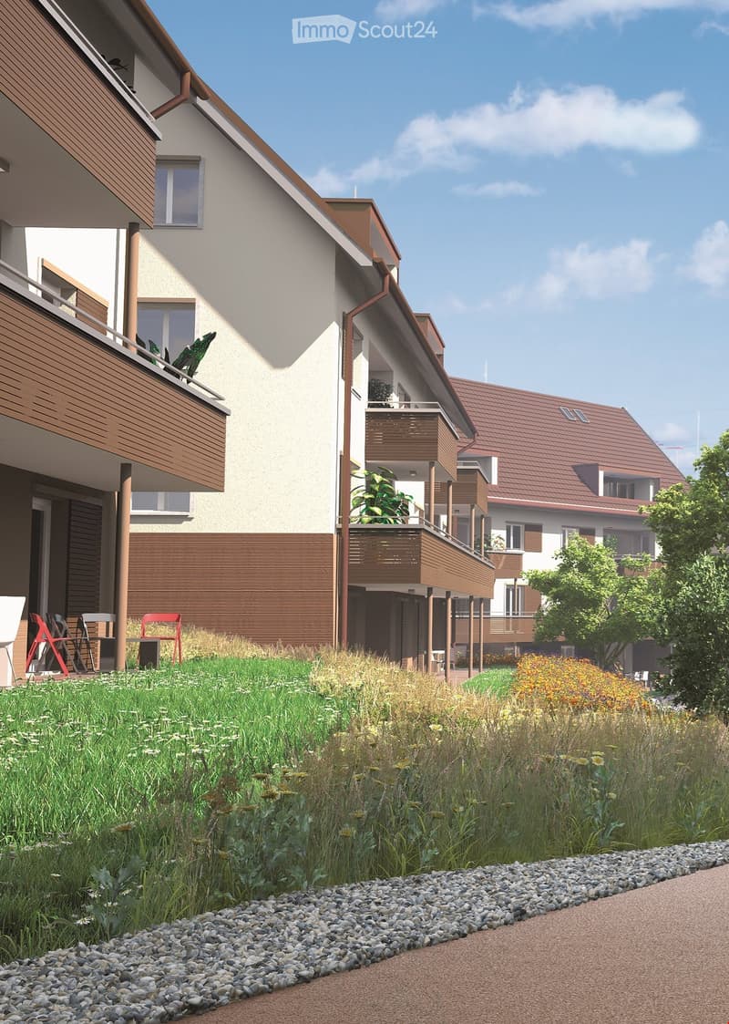 Apartment building with balconies, multiple floors, brown walls, plants on the balconies, pathway in the front
