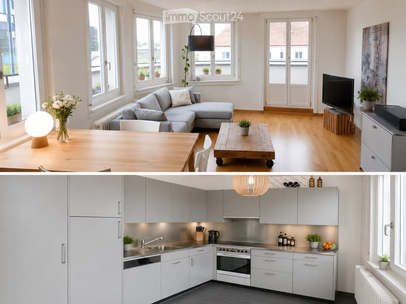 The image shows a modern, well-lit living room and kitchen area. The living room features a grey sectional sofa, a wooden coffee table, a dining table with chairs, a floor lamp, and a television on a stand. The kitchen has white cabinets, a stainless stee