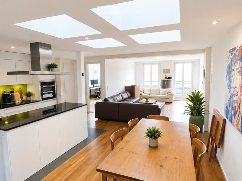 Open-plan living and dining area with modern furniture, including a dark brown sofa, a white armchair, a wooden dining table with chairs, and a sleek kitchen with white cabinets and black countertops.