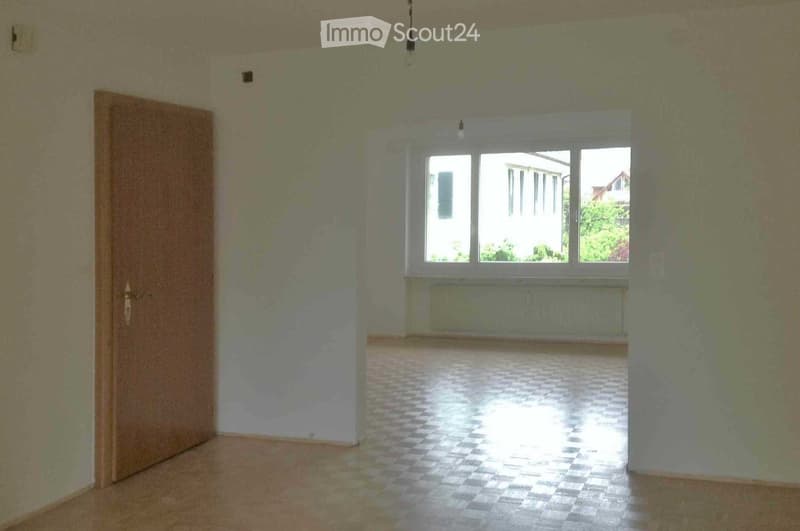 Empty room with bare walls, tiled floor, and large windows allowing natural light. No furniture or equipment present.