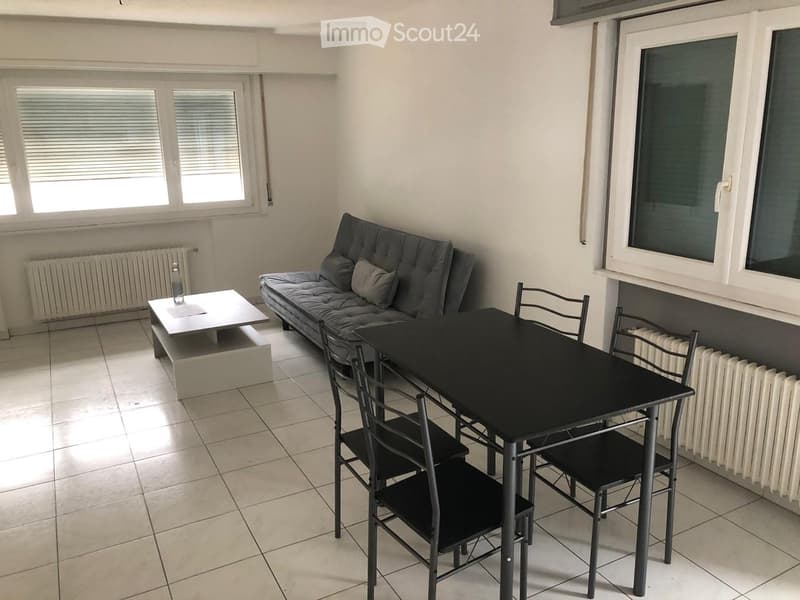modern living room with a couch, dining table, white tiled floor, double windows, and heaters on both sides