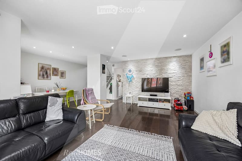 modern living room, black leather sofas, white rug, white entertainment center, flat screen TV, white walls, wooden floor