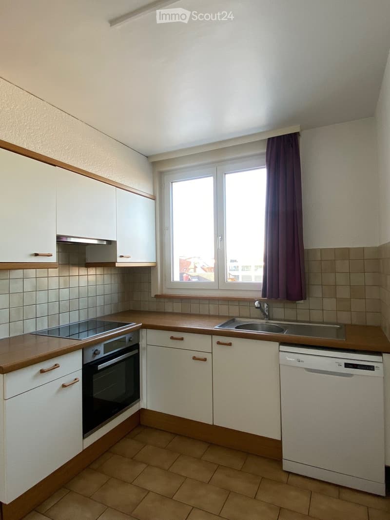modern kitchen, tile flooring, window, stainless steel appliances, cabinets, sink, faucet