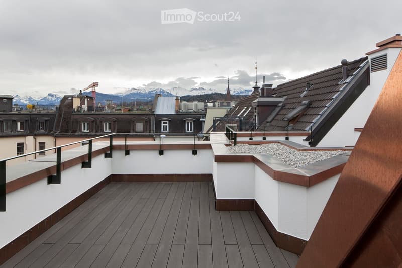 wooden floor, metal railing, gravel, view of mountains