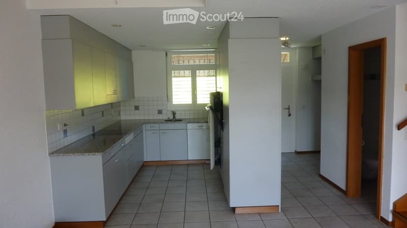 Modern kitchen with white cabinets, granite countertop, tiled backsplash, and stainless steel appliances including a sink, faucet, refrigerator, and dishwasher.