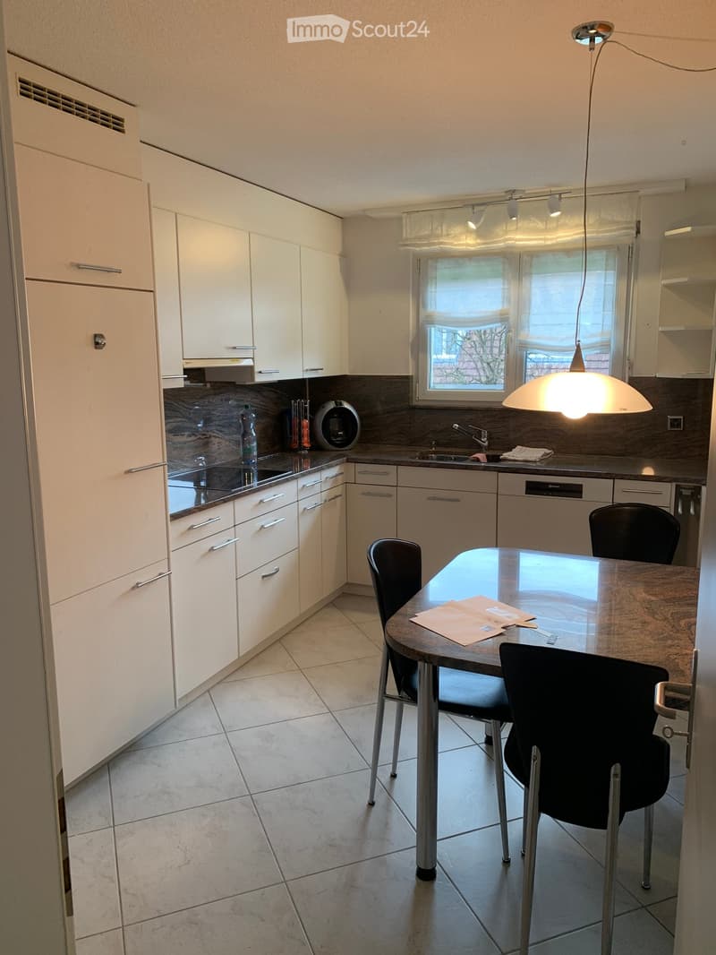 modern kitchen with white cabinets, granite countertops, stainless steel appliances, tiled floor, dining table, chairs, sink, faucet, window