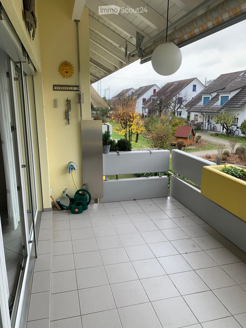 tiled floor, white walls, glass door, balcony railing, hanging lamp, cleaning tools, potted plants