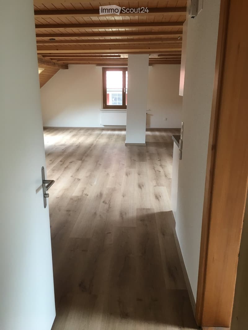 empty room, wooden flooring, white walls, wooden ceiling, window, wooden beam