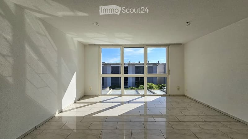 Empty room with large windows, tiled floor, and natural light streaming in. No furniture or equipment present.