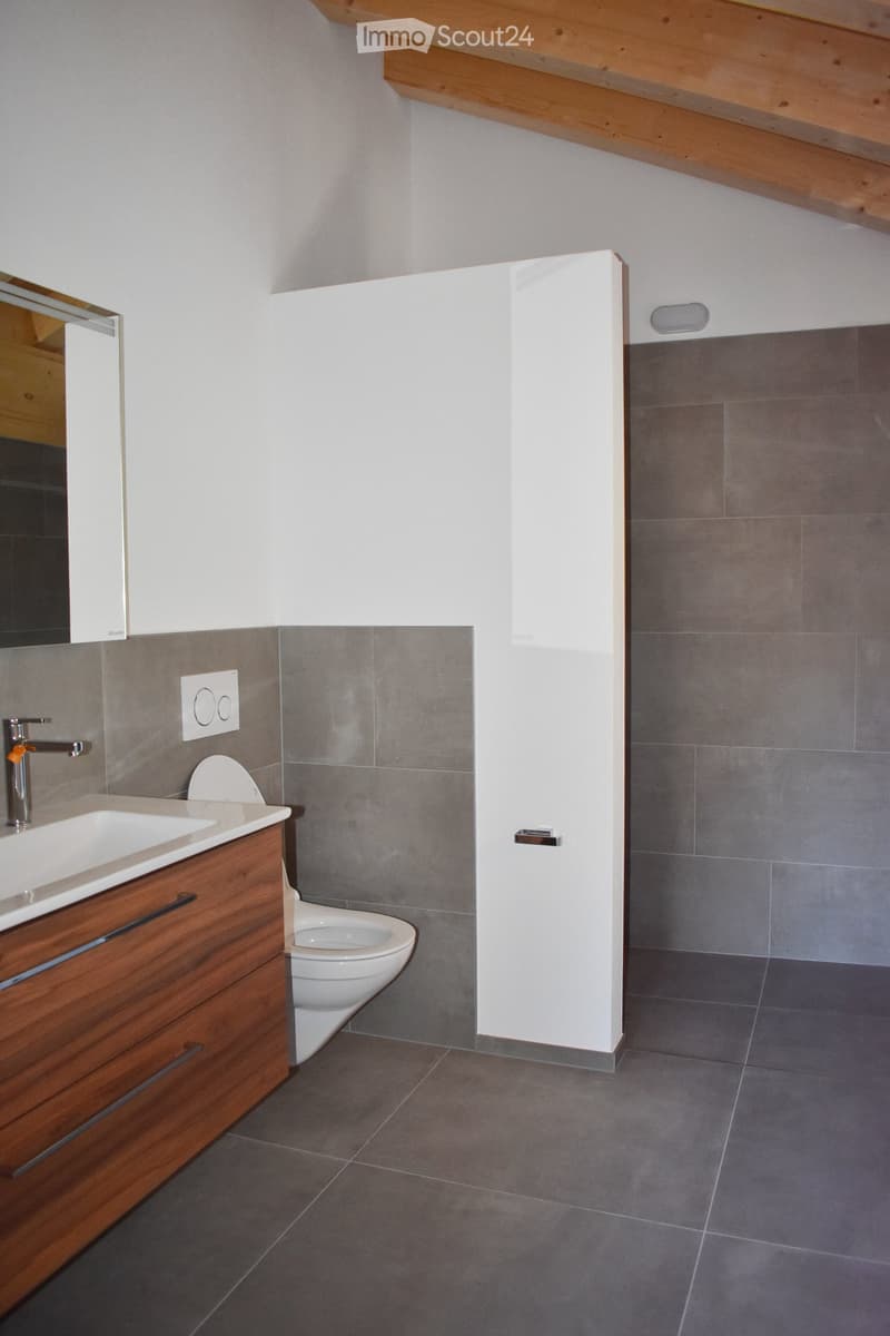modern bathroom, white tiles, wooden vanity, white toilet, gray floor, wooden ceiling, mirror