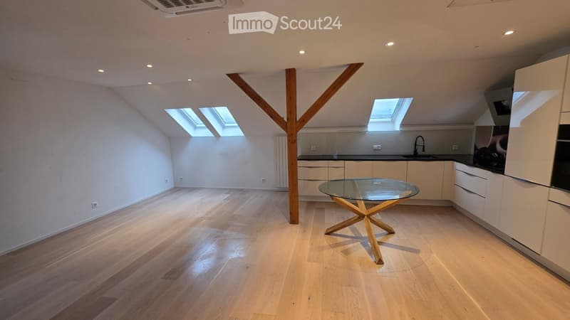 empty room, wooden floor, glass table, white kitchen, 3 skylights, wooden beam