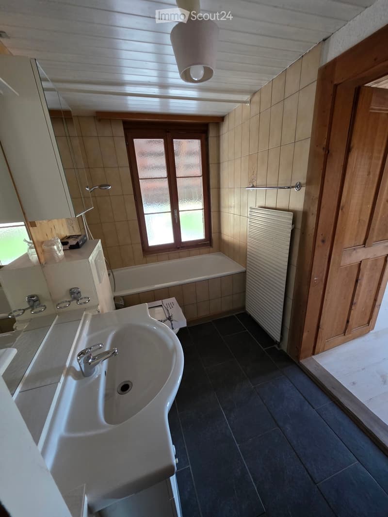 white tiles, bathtub, sink, white towel, wall mounted shower, radiator