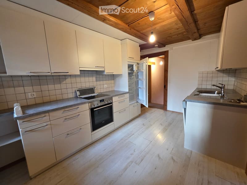 modern kitchen with white cabinets, stainless steel appliances, tile flooring, wooden ceiling, sink with faucet