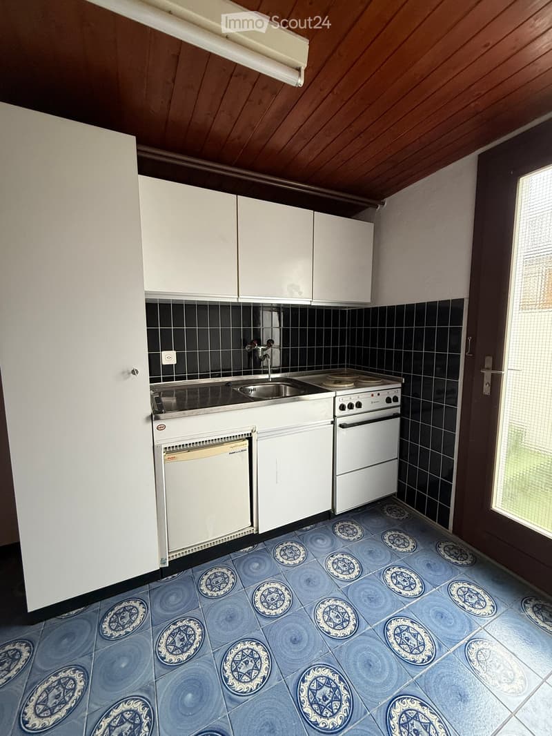 White cabinets, tiled floor, sink, gas stove, dishwasher, power outlet
