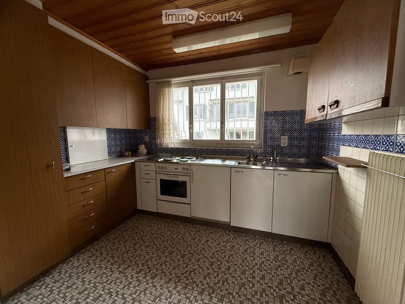 wooden cabinets, tile backsplash, electric stove, sink, white appliances, tiled floor