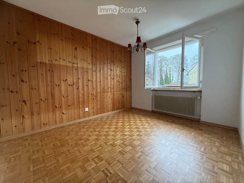 Parquet floor, wooden paneling, radiator, chandelier, window, open window