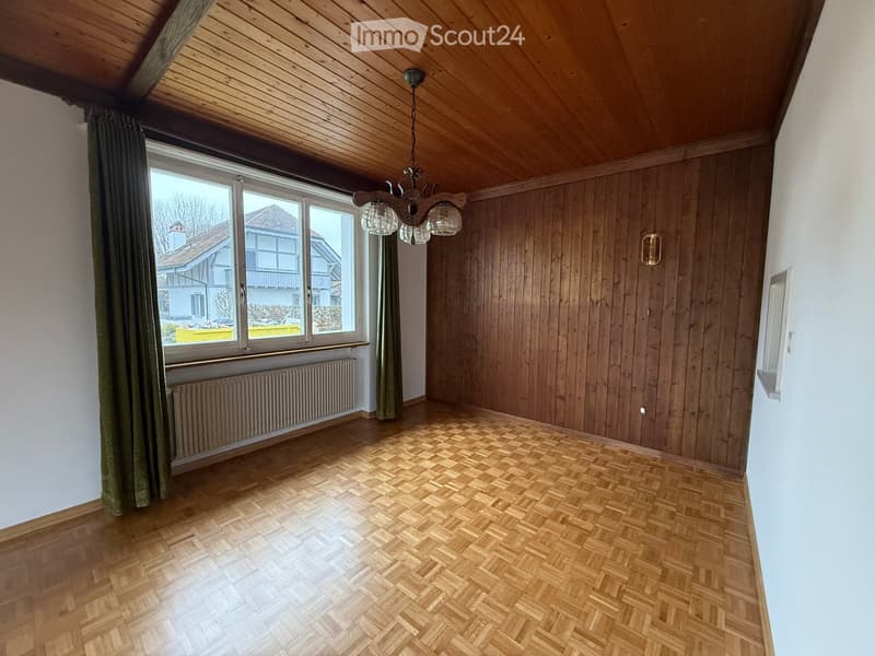hardwood floor, wooden wall, chandelier, white curtains, window, radiator, white wall