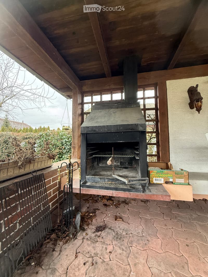 an open fireplace is in the middle of the room