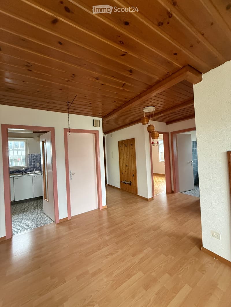 living room, wooden ceiling, hard wood floors, doors, white walls, kitchen, bathroom