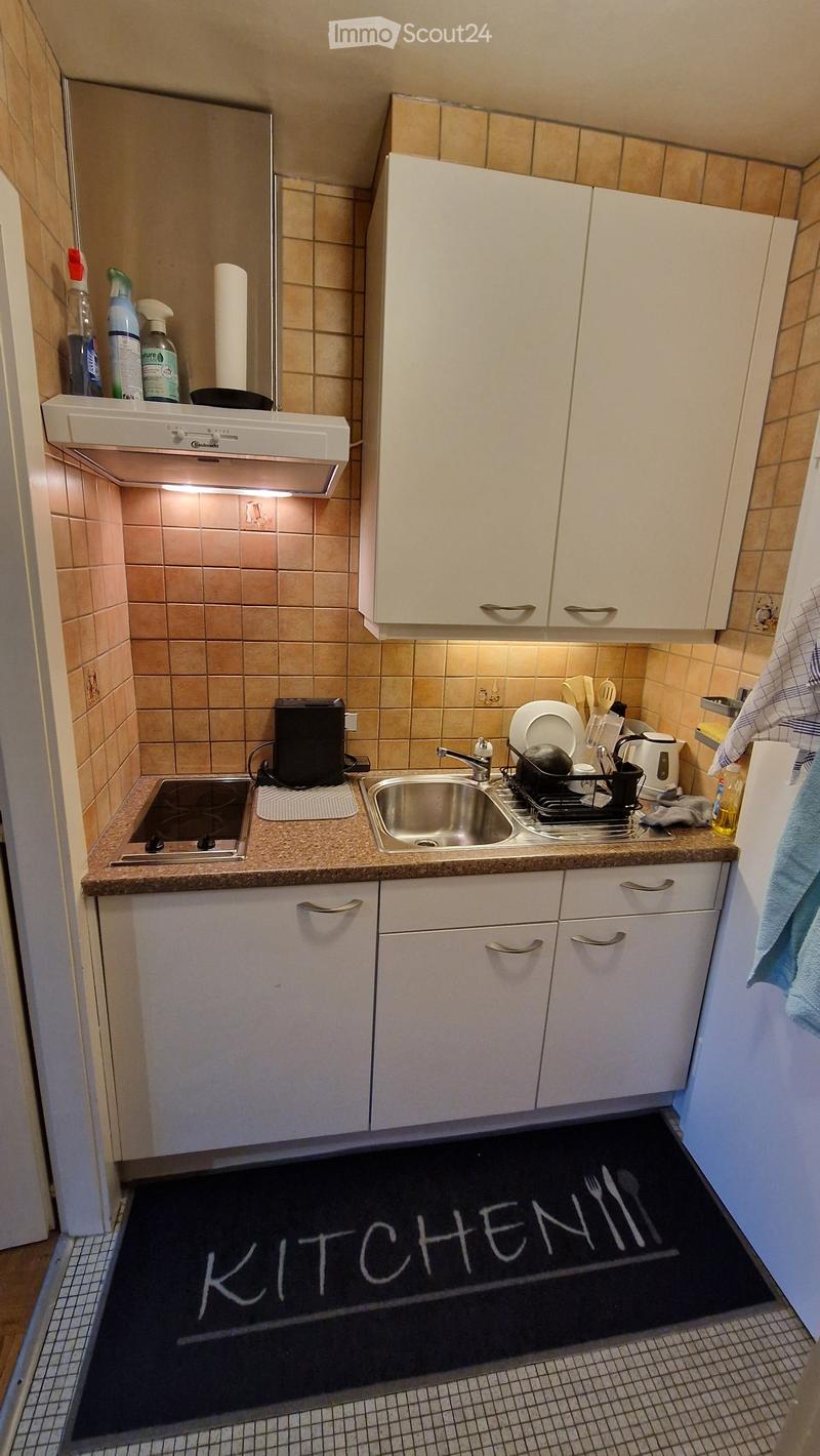 kitchen with white cabinets, tiled walls, sink, stove, dishwasher, kitchen mat