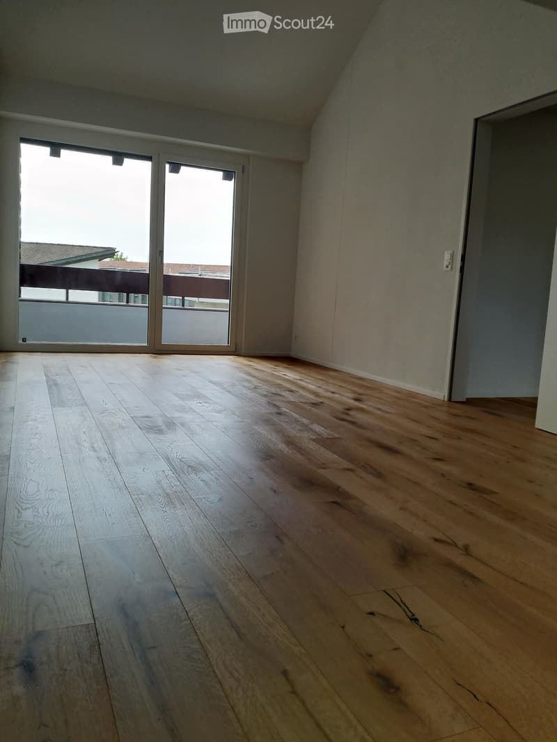 empty room, wooden floor, sliding doors to balcony, white walls
