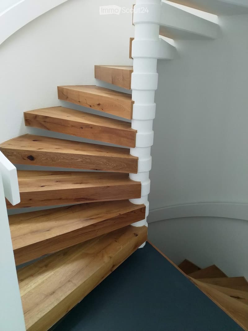 White railing, wooden staircase, white interior wall
