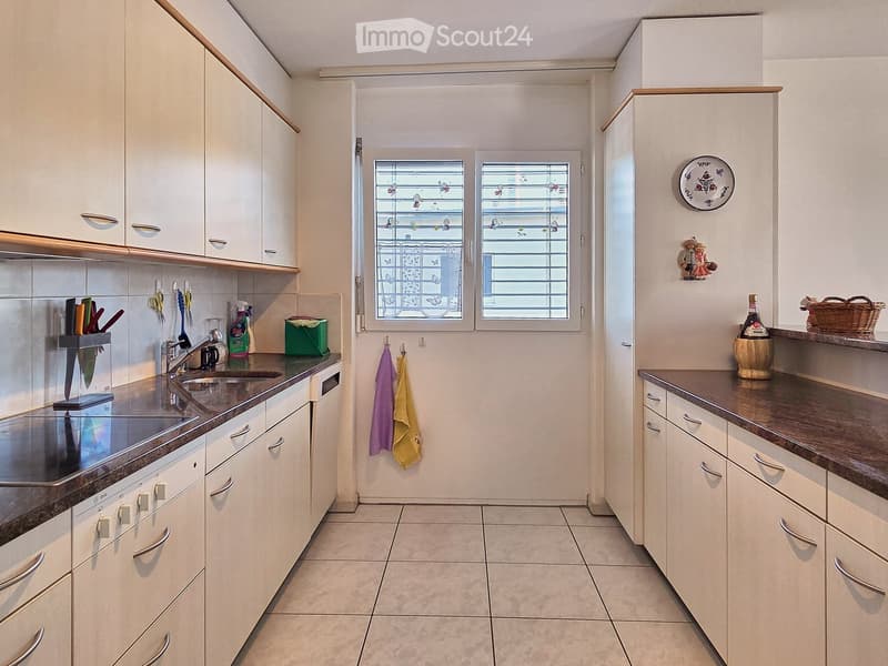 modern kitchen, white cabinets, granite countertops, stainless steel appliances, tiled floor, window with blinds, decorative items