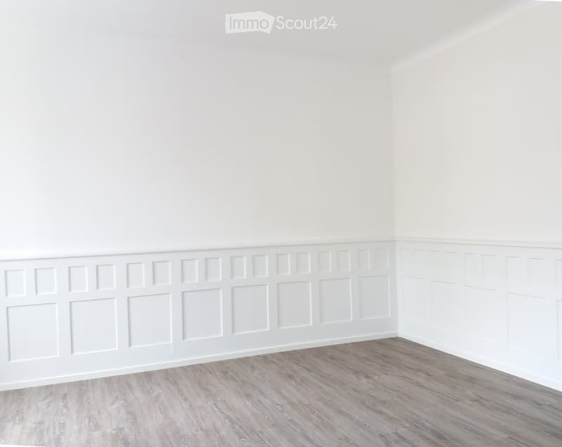 Completely empty room with white walls and light wooden flooring. No furniture or equipment.